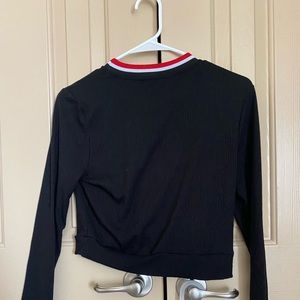 Long sleeve black crop top with red and white around the neck